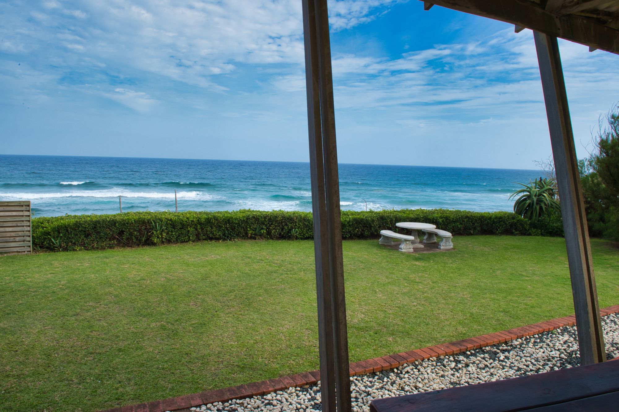 Angled sunset over sea view from holiday home, under patio, left side